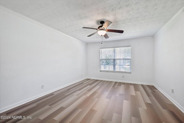 unfurnished room with a textured ceiling, crown molding, ceiling fan, and hardwood / wood-style flooring