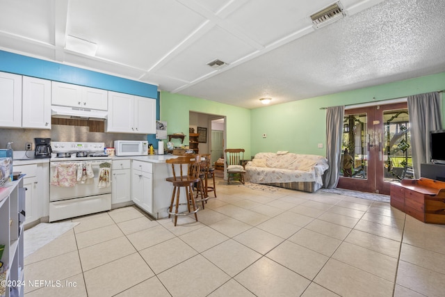 kitchen with white cabinets, light tile patterned floors, white appliances, french doors, and a textured ceiling