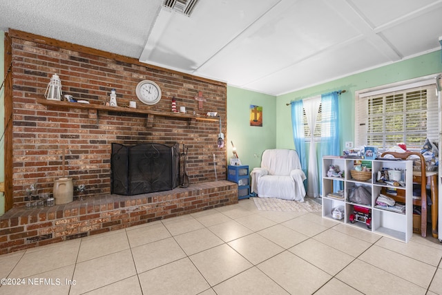 living room featuring a brick fireplace, a textured ceiling, and light tile patterned floors