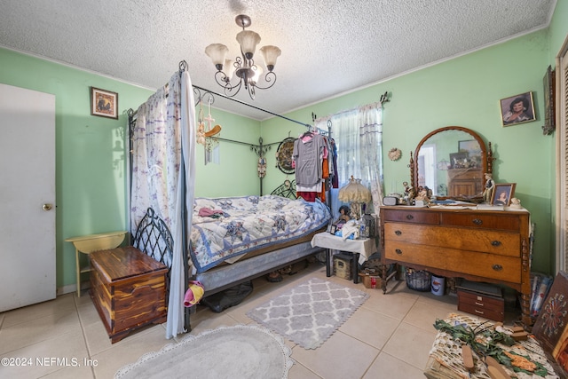 tiled bedroom featuring an inviting chandelier and a textured ceiling