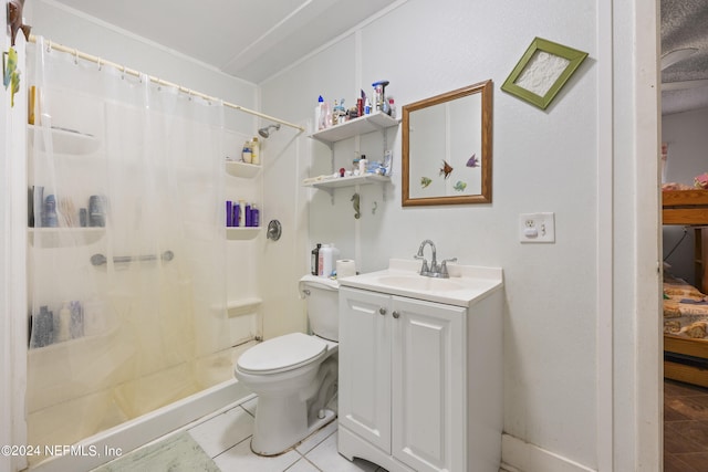 bathroom featuring toilet, vanity, a shower with shower curtain, and tile patterned floors