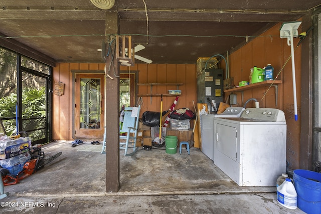 interior space featuring heating unit, wood walls, and separate washer and dryer