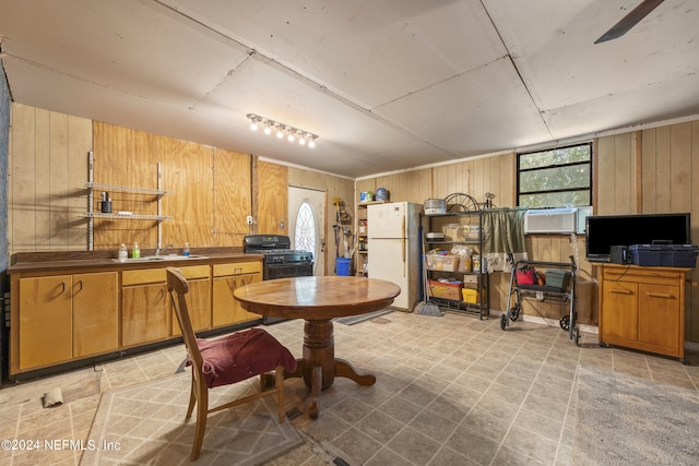 kitchen featuring wooden walls and white refrigerator