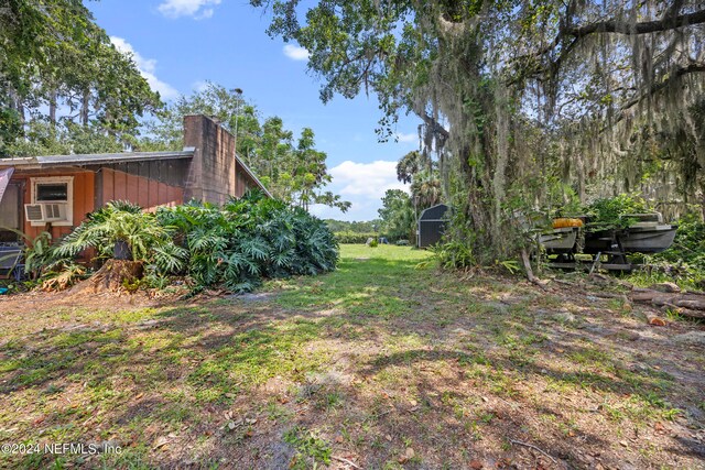 view of yard featuring an outbuilding and cooling unit