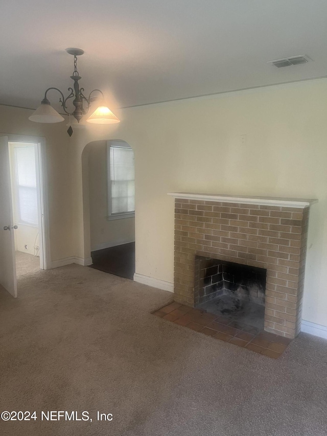 unfurnished living room with visible vents, carpet flooring, a brick fireplace, and baseboards