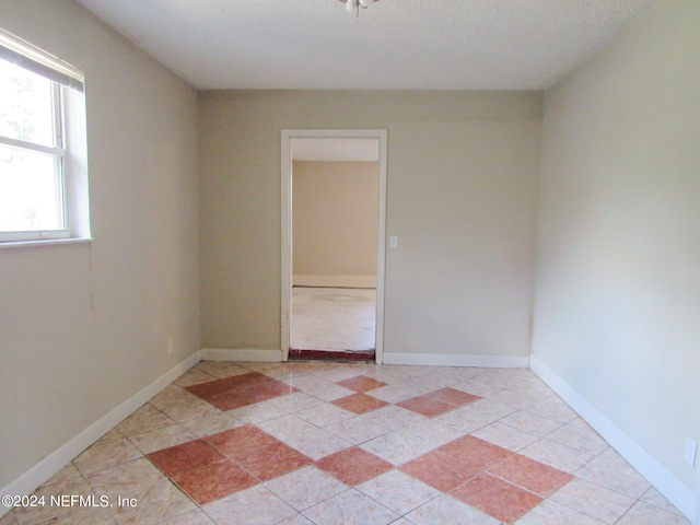 empty room featuring a textured ceiling