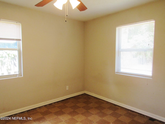 unfurnished room with a wealth of natural light and ceiling fan