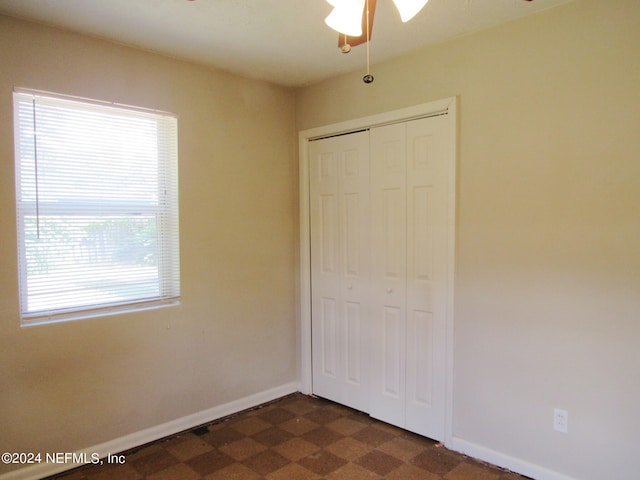 unfurnished bedroom with a closet and ceiling fan