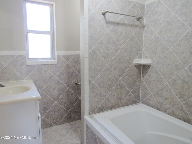 bathroom featuring vanity, a healthy amount of sunlight, and separate shower and tub