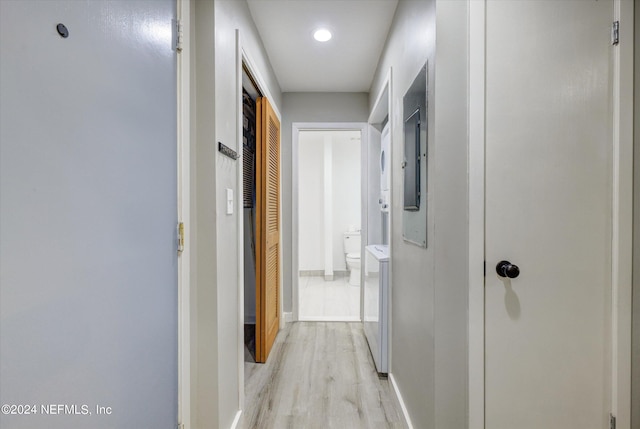 hall with washer and dryer and light hardwood / wood-style floors