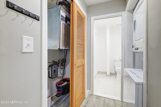 interior space featuring stacked washer / dryer and light hardwood / wood-style floors