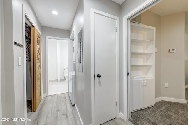 corridor featuring washer / dryer and light hardwood / wood-style floors