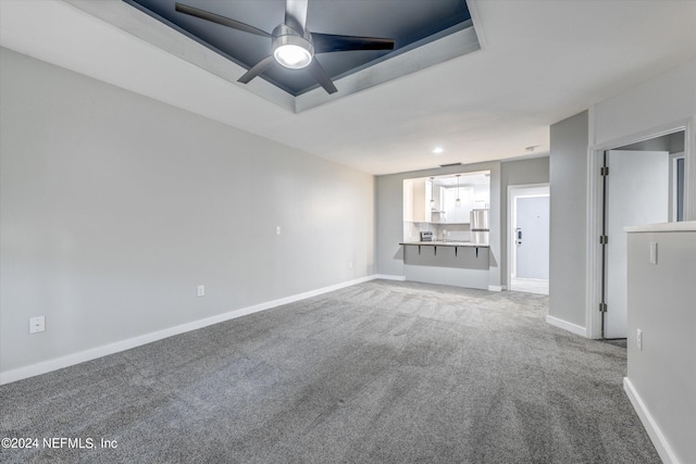 unfurnished living room featuring carpet flooring and ceiling fan