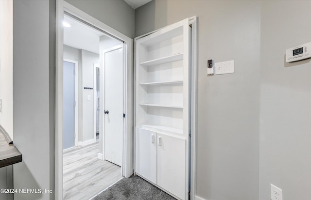 hallway with hardwood / wood-style floors