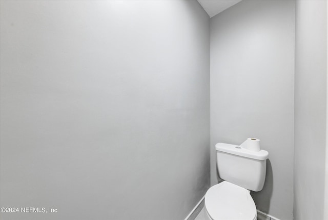 bathroom featuring toilet and lofted ceiling