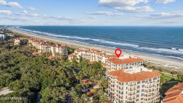 bird's eye view featuring a view of the beach and a water view