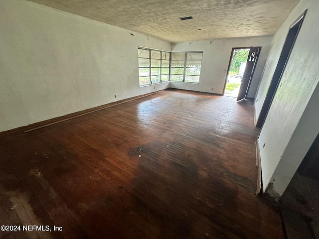 spare room with dark hardwood / wood-style floors