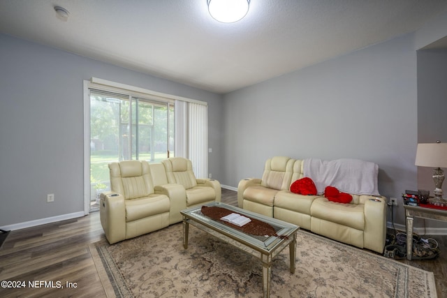 living area featuring baseboards and wood finished floors