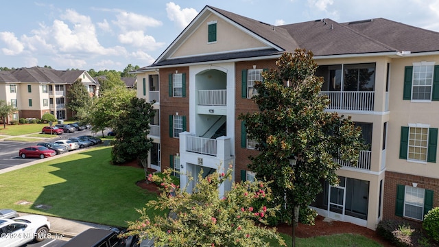 view of property with uncovered parking and a residential view