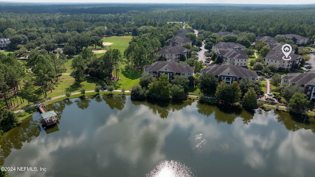 aerial view featuring a forest view, a residential view, and a water view
