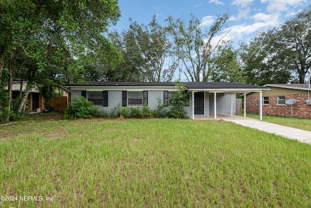 ranch-style home featuring a front yard and a carport