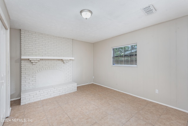 empty room featuring a fireplace and a textured ceiling