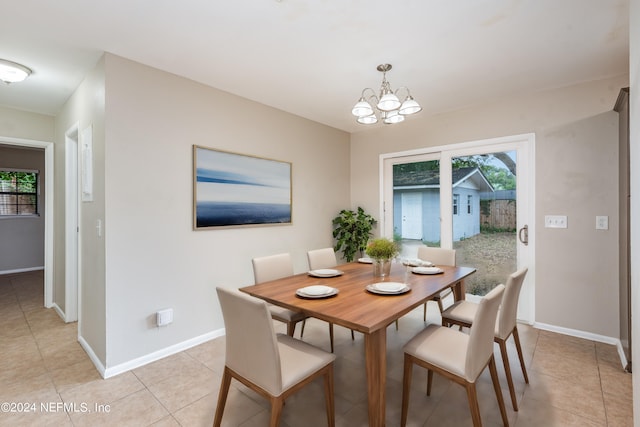 tiled dining area with a chandelier