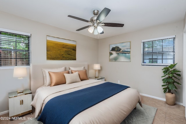 tiled bedroom featuring ceiling fan