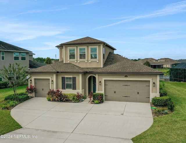 view of front of house featuring a garage and a front lawn