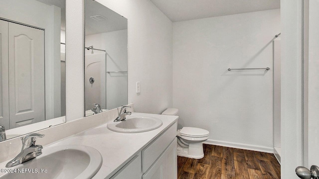 full bathroom featuring a shower, a sink, toilet, and wood finished floors