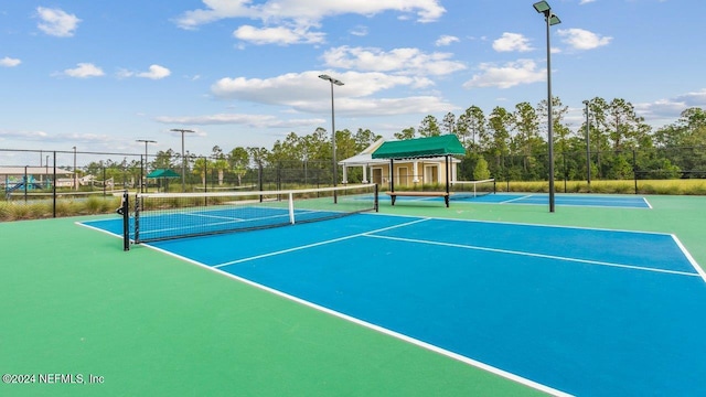 view of sport court featuring fence