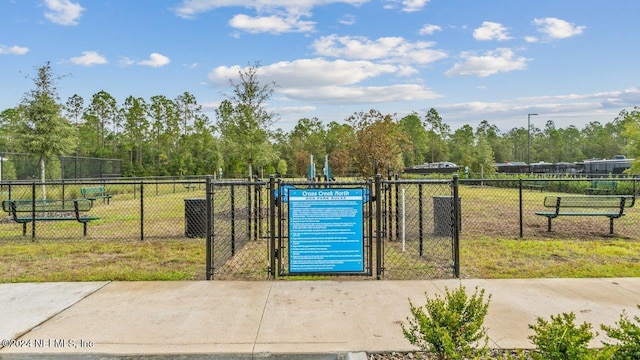 view of home's community featuring a gate and fence