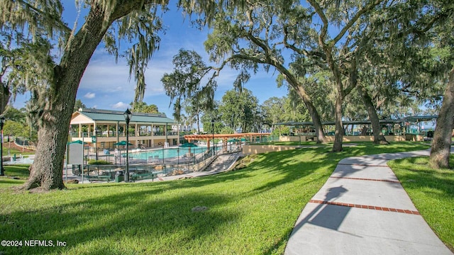 view of community featuring a yard and a pool