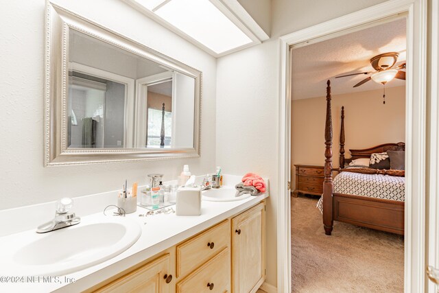 bathroom featuring ceiling fan and vanity