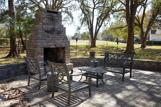 view of patio / terrace with an outdoor stone fireplace