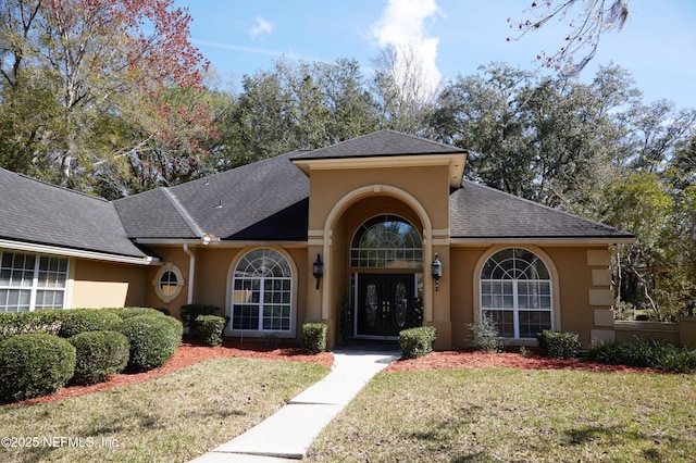 view of front of home with french doors and a front yard