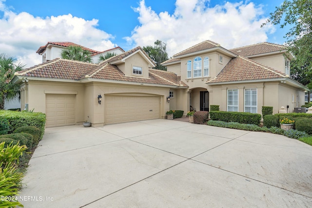 mediterranean / spanish-style home featuring a garage