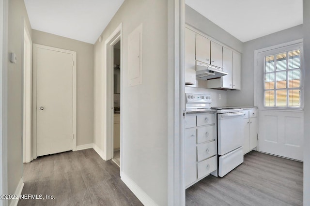 kitchen with light wood finished floors, white cabinets, electric range, and under cabinet range hood