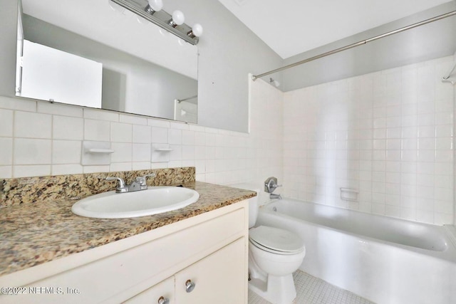 full bath featuring vanity, tile walls, toilet, shower / washtub combination, and backsplash