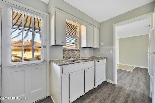kitchen featuring baseboards, dark wood-type flooring, white cabinetry, a sink, and white dishwasher