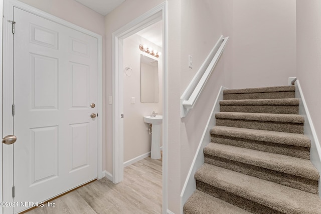 stairs with wood-type flooring