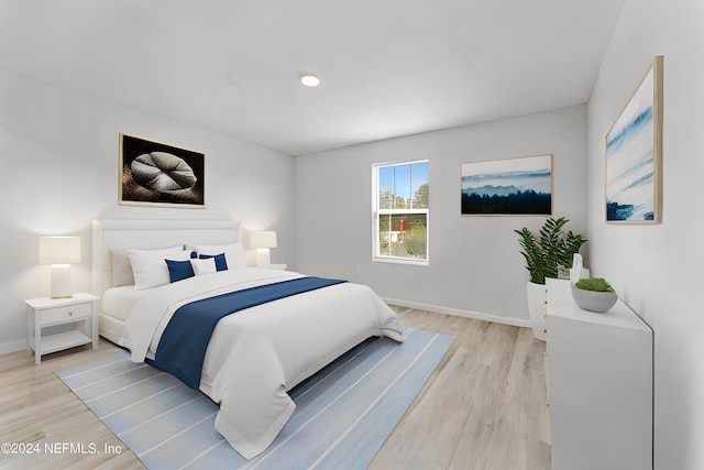 bedroom with light wood-style floors and baseboards