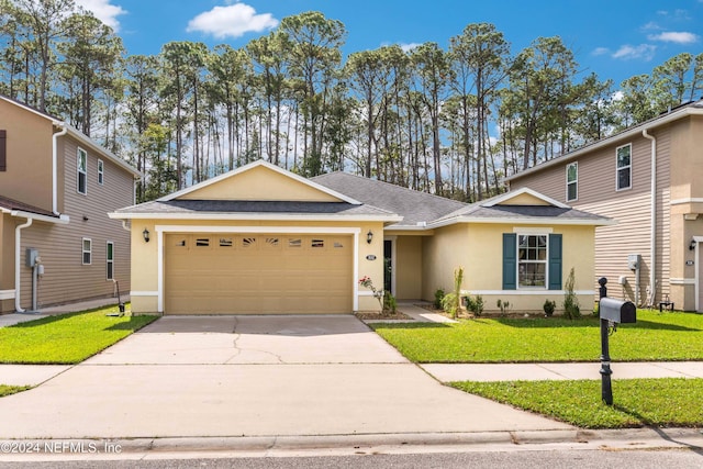 view of front of home featuring a front lawn and a garage