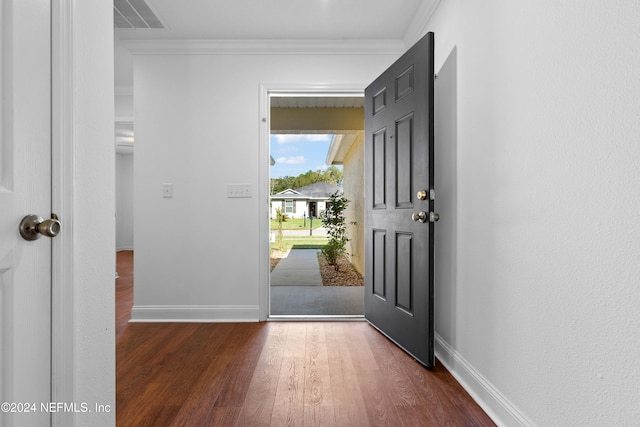 doorway with dark wood-type flooring and ornamental molding