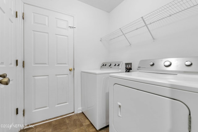 clothes washing area featuring separate washer and dryer