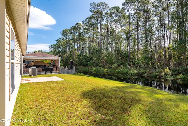 view of yard featuring a gazebo, a patio, and a water view