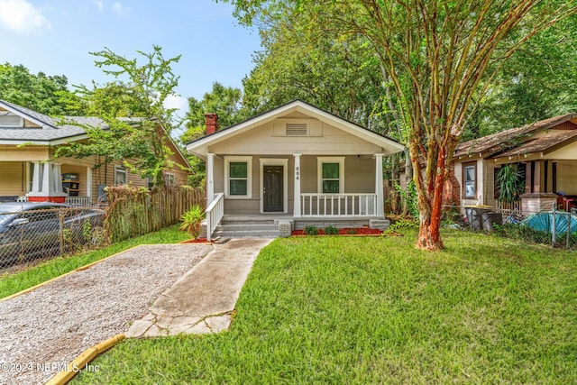 bungalow with a porch and a front yard