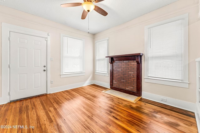 interior space with a textured ceiling, light hardwood / wood-style flooring, and ceiling fan