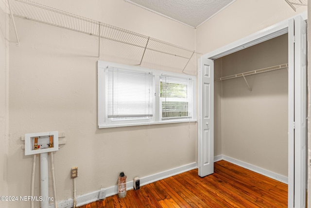 unfurnished bedroom featuring a closet and hardwood / wood-style flooring