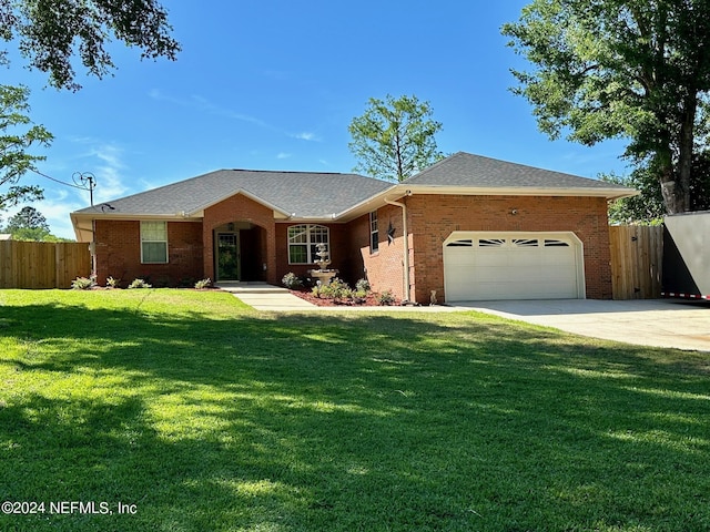 ranch-style home with an attached garage, brick siding, fence, concrete driveway, and a front lawn